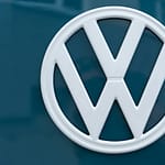 silver mercedes benz emblem on blue surface