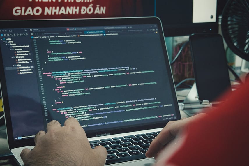 a man sitting in front of a laptop computer