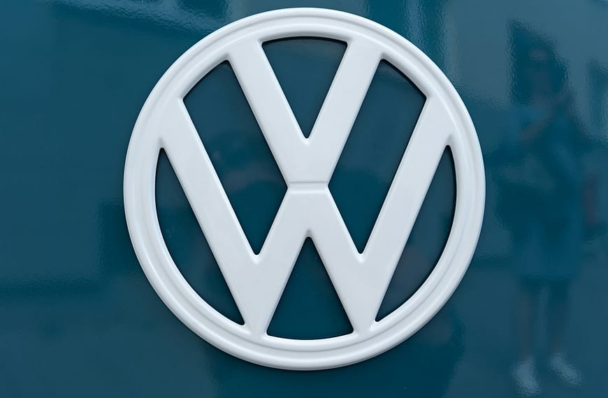 silver mercedes benz emblem on blue surface