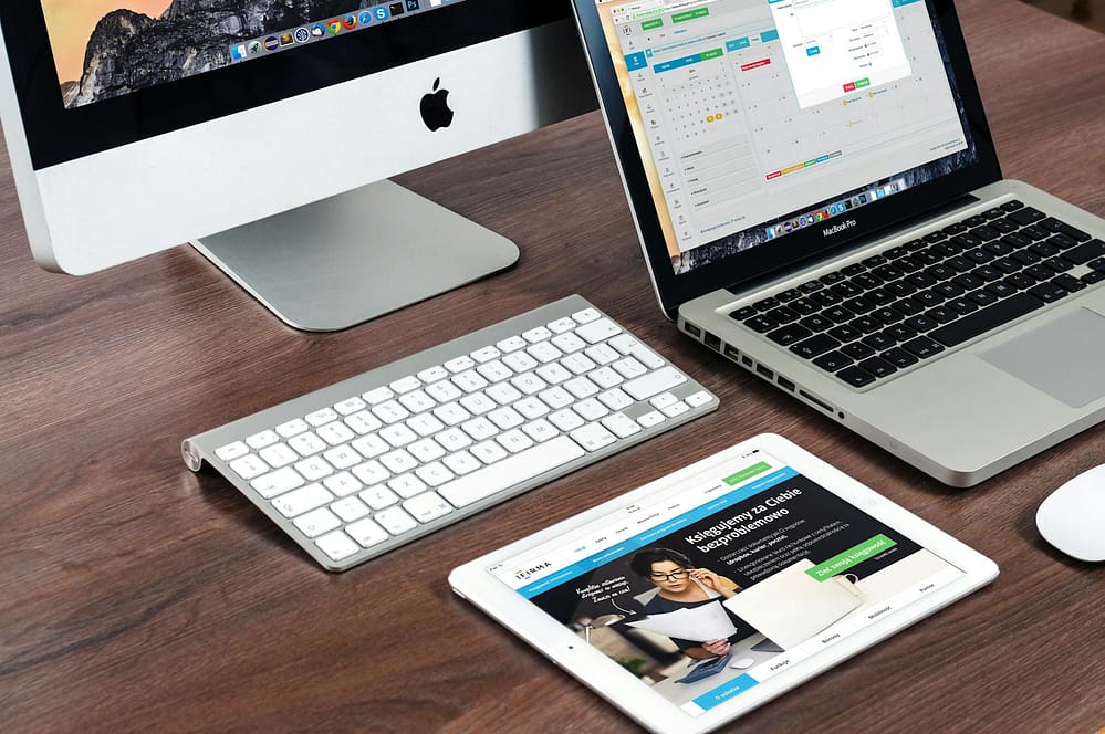 Top 10 Latest Technology Trends Explained for Beginners (2025 Guide) 1 A sleek office desk setup featuring Apple devices: iMac, MacBook, and iPad.