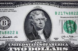 us dollar bill on black and white textile