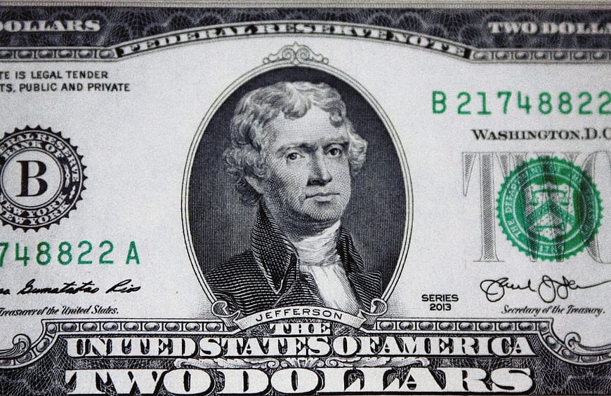 us dollar bill on black and white textile