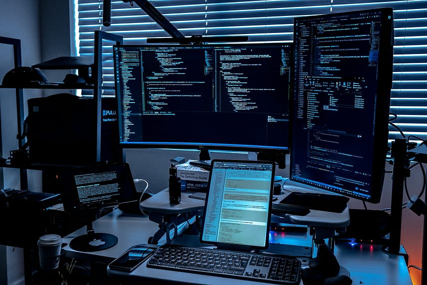 a desk with several monitors