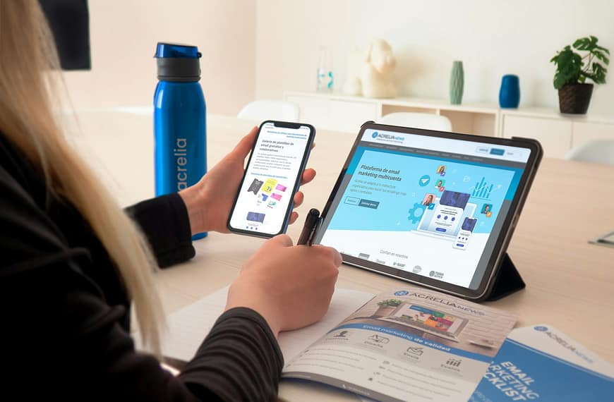 a woman sitting at a table using a tablet